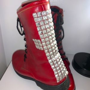 Red combat boots with silver studded cross